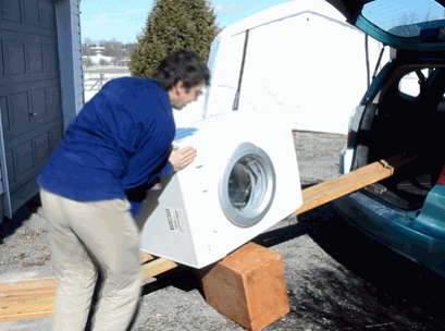 Loading Up The Washing Machine Onto The Moving Vehicle